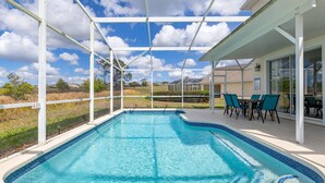 Piscina com um terraço coberto, área de estar externa e vista para a paisagem ao redor.