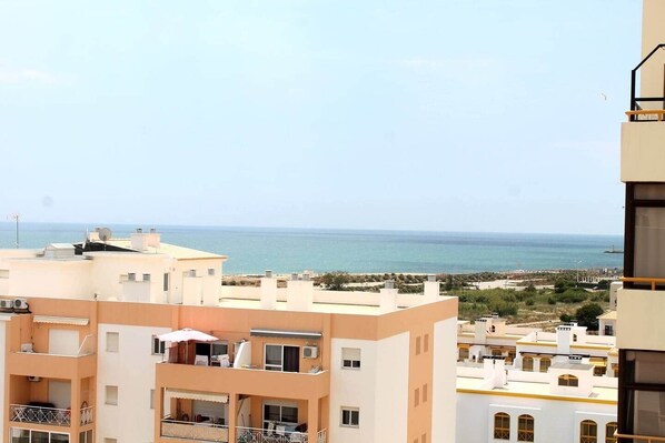 A coastal residential area with buildings overlooking the sea. - Rooftop Sea View Apartment (Quarteira)