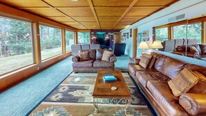 A spacious living area with leather sofas, a coffee table, and a large rug. - The View: stunning Wallowa Lake views! (Joseph)