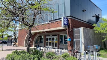 A METRO station with a brick facade, a covered entrance, and a bike parking area.