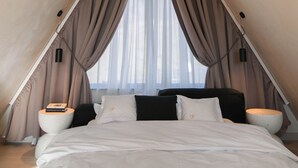 A tent-style bedroom with a bed, curtains, and pendant lights. - Twin Vista A-Frame Cabins (Sovata)