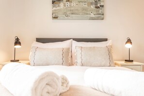A neatly made bed with white linens and two bedside lamps. - The Deck House | St Monans (St Monans)