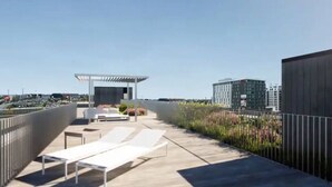 A rooftop terrace with sun loungers, a covered seating area, and a view of surrounding buildings. - Romema *201* - Condo Luxe 1 bdr (Montreal)
