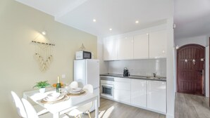 A modern kitchen with white cabinets, a microwave, and a sink. - Vacation Apartment 'Tagoropark Relax' with Shared Pool, Private Terrace and Wi-Fi (Costa del Silencio)