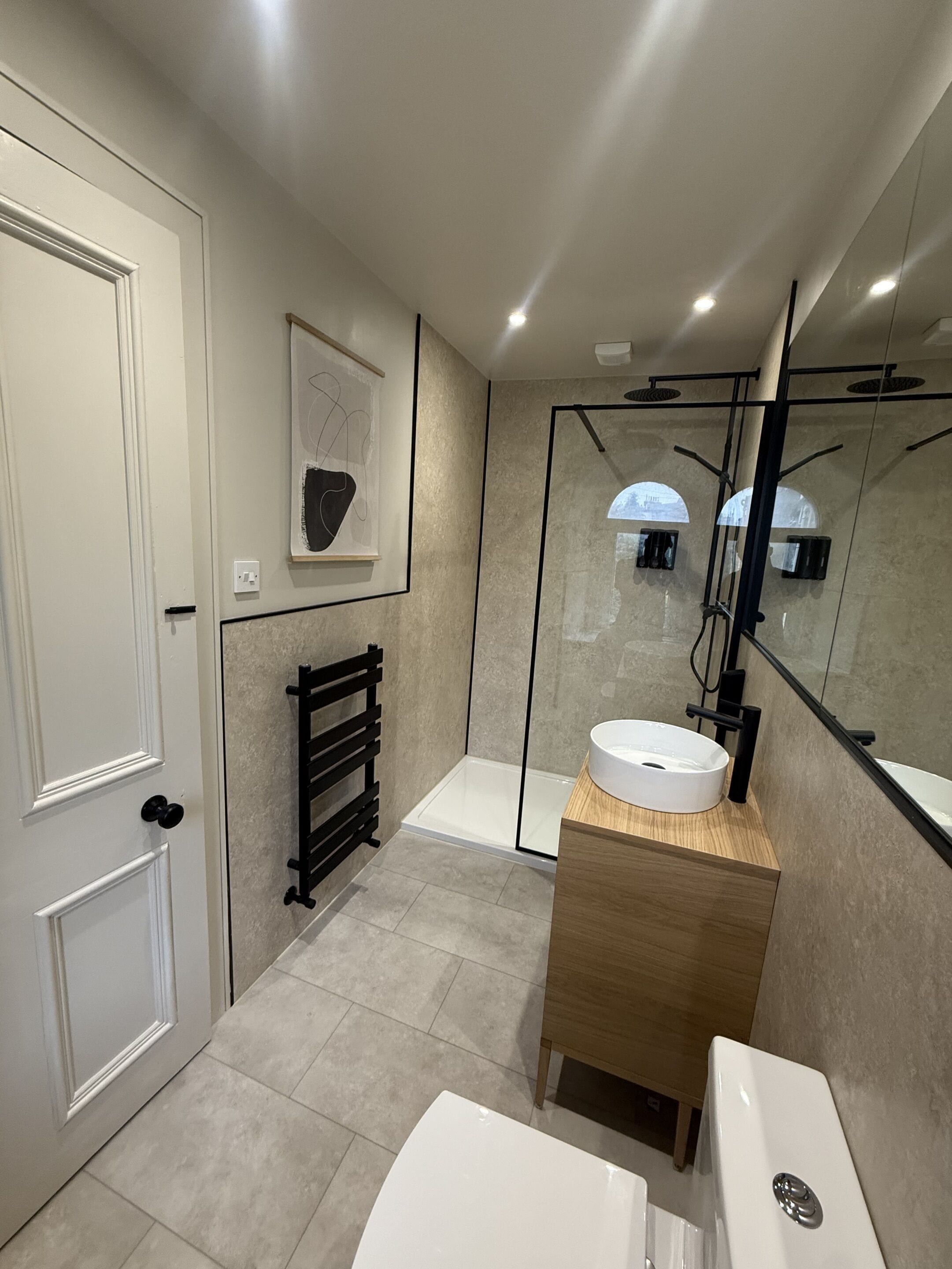 A modern bathroom with a bathtub, a sink, and a shower.
