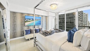 A modern bedroom with a large bed, a TV mounted on the wall, and a balcony with a city view. - ICON 2211 · ★Inredible View -Luxury Unit at the W Brickell★ (Miami)