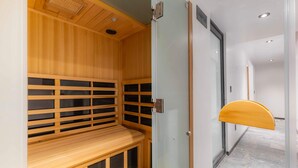 A sauna room with wooden benches and glass doors. - Michoacan Space Lovely Apartment With Balcony (Mexico City)