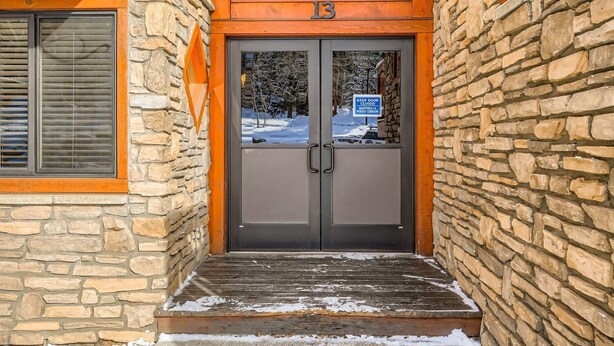 Un edificio de piedra con una puerta de madera marcada con el número 13.