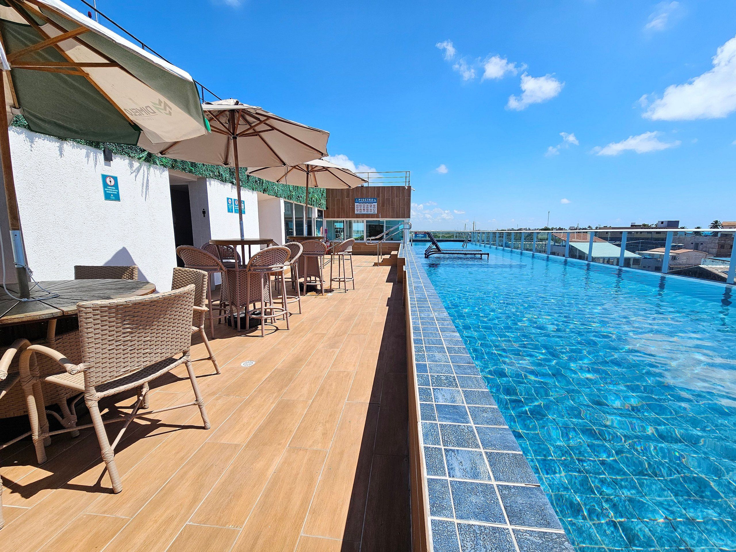 A poolside area with outdoor seating and a clear view of the pool.
