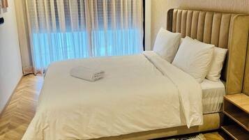 Tabla de planchar con plancha, internet y ropa de cama