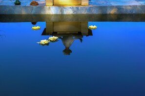 A calm water feature with a stone structure above and lotus flowers floating on the surface. - Saygın Farmhouse Ephesus Boutique Hotel (Tire)