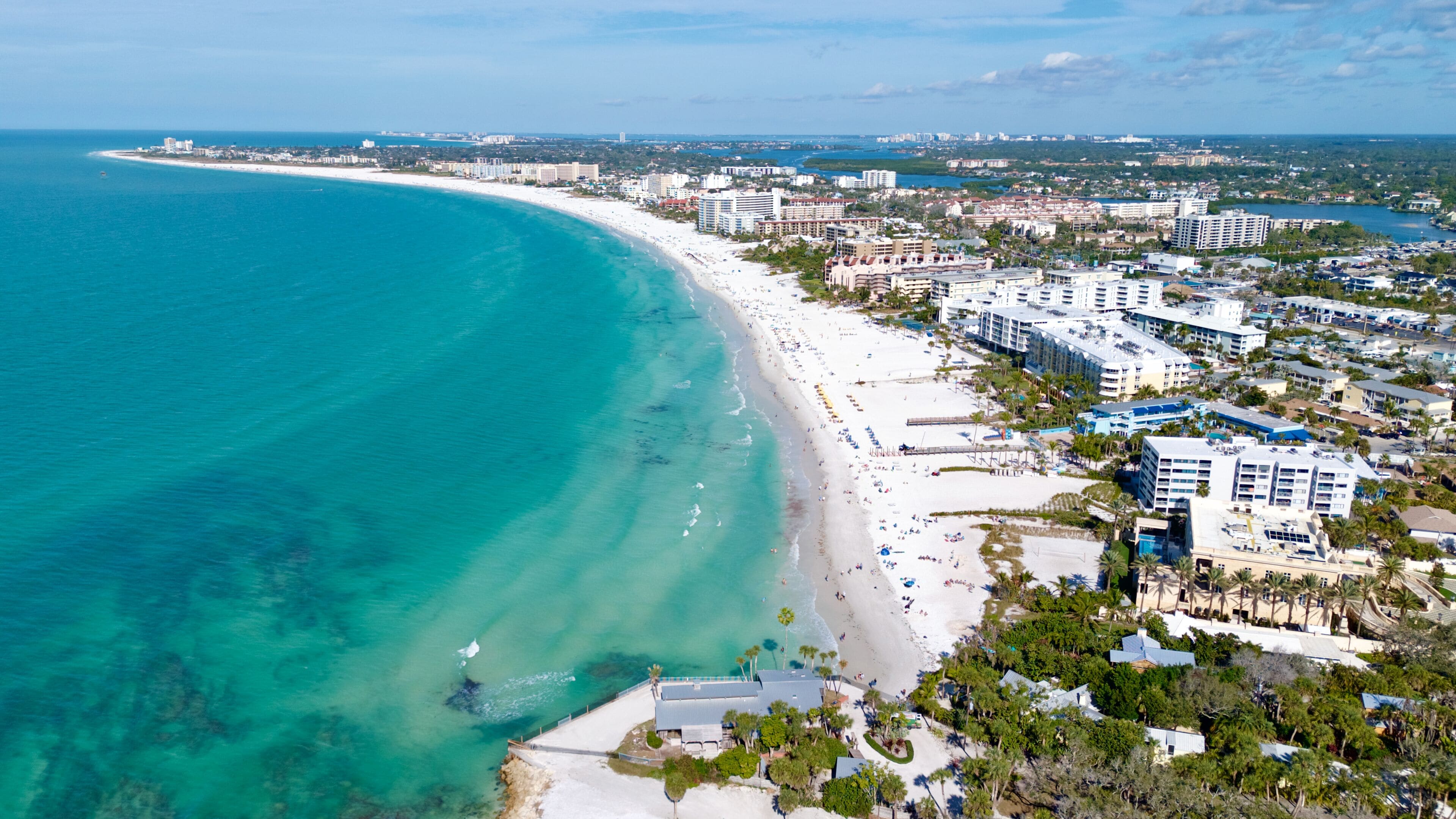 On the beach, white sand, sun-loungers, beach umbrellas