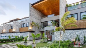 A modern building with a stone facade, wooden accents, and a well-maintained garden. - House w/ Pool and Barbecue Grill Sgt0000 (Porto de Pedras)