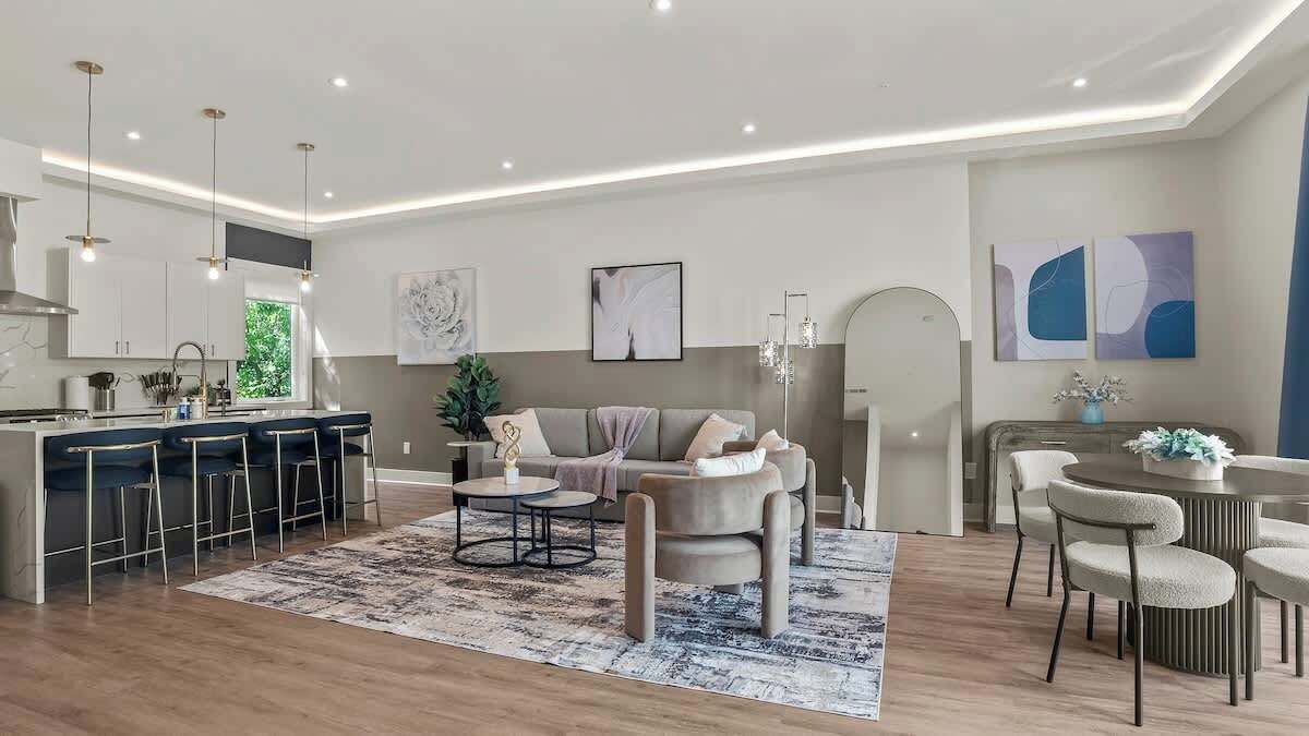 A modern living room with a sofa, coffee table, and dining area.