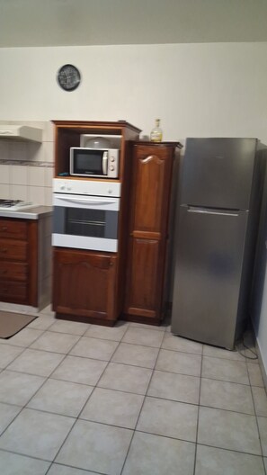 A kitchen with a microwave, oven, and refrigerator. - LET THE SONG OF THE BIRDS LULLE YOU TO SLEEP (Sainte-Luce)