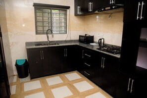 Standard Apartment, Balcony | Private kitchen | Full-size fridge, microwave, oven, cookware/dishes/utensils - CREMYARK HOME APARTMENTS (Benin City)