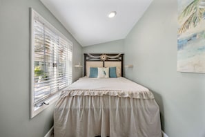 A bedroom with a bed, a window with blinds, a ceiling light, and a wall-mounted painting. - Coastal Haven Getaway, Beach Stay & Resort Perks! (Myrtle Beach)