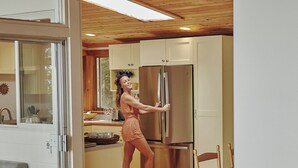 A modern kitchen with wooden cabinets and a stainless steel refrigerator. - Private lakeside hideaway, 4 bedroom one-story home with stunning water views. (Sebago)