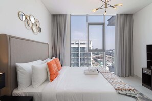 A modern hotel room with a large bed, a view of the cityscape, and a unique wall art piece. - Stayshort - 1 Bed Unit in Meydan Sleeps 2 With Balcony (Dubai)
