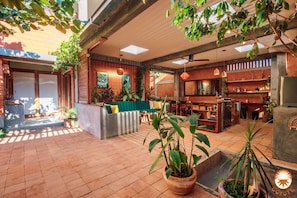 A spacious indoor area with a seating area, a kitchen, and a dining space.