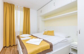 A hotel room with a bed, a nightstand, and a wardrobe. - 2 bedroom cozy apartment in Punat (Punat)