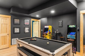 A pool table with a cue ball, two arcade games, and framed chessboards on the wall. - Black Diamond Retreat 7BR Sleeps 18 Hot Tub+Sauna 3 Min to Massanutten Slopes (McGaheysville)