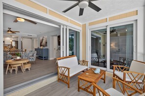 A spacious living area with a sofa, chairs, and a dining table. - Villa Sanibel 1B | Right on the Beach in Sanibel (Sanibel)