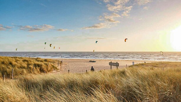 A beach with windsurfing activity and a sign in the foreground. - Stunning home in La Barre de Monts (La Barre de Monts)