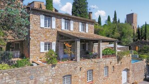 A stone house with multiple windows, a covered porch, and a pool area. - Lovely home in Les Arcs with private swimming pool, can be inside or outside (Les Arcs)