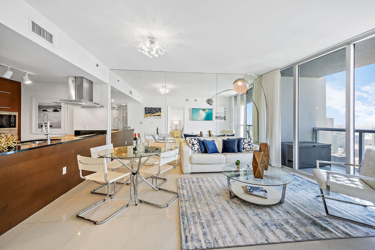 A modern apartment with a kitchen, dining area, and living room.