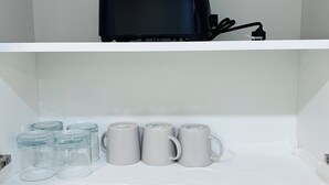 A white shelf with a black bag and three grey mugs. - Sudio Basement Suite with Double Bed and kitchen, Entrance from Garage -Sleeps 2 (Milton)