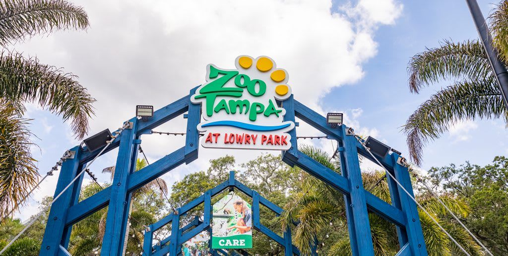 Schild für den Zoo Tampa at Lowry Park mit einem 'Fürsorglichkeit'-Symbol.