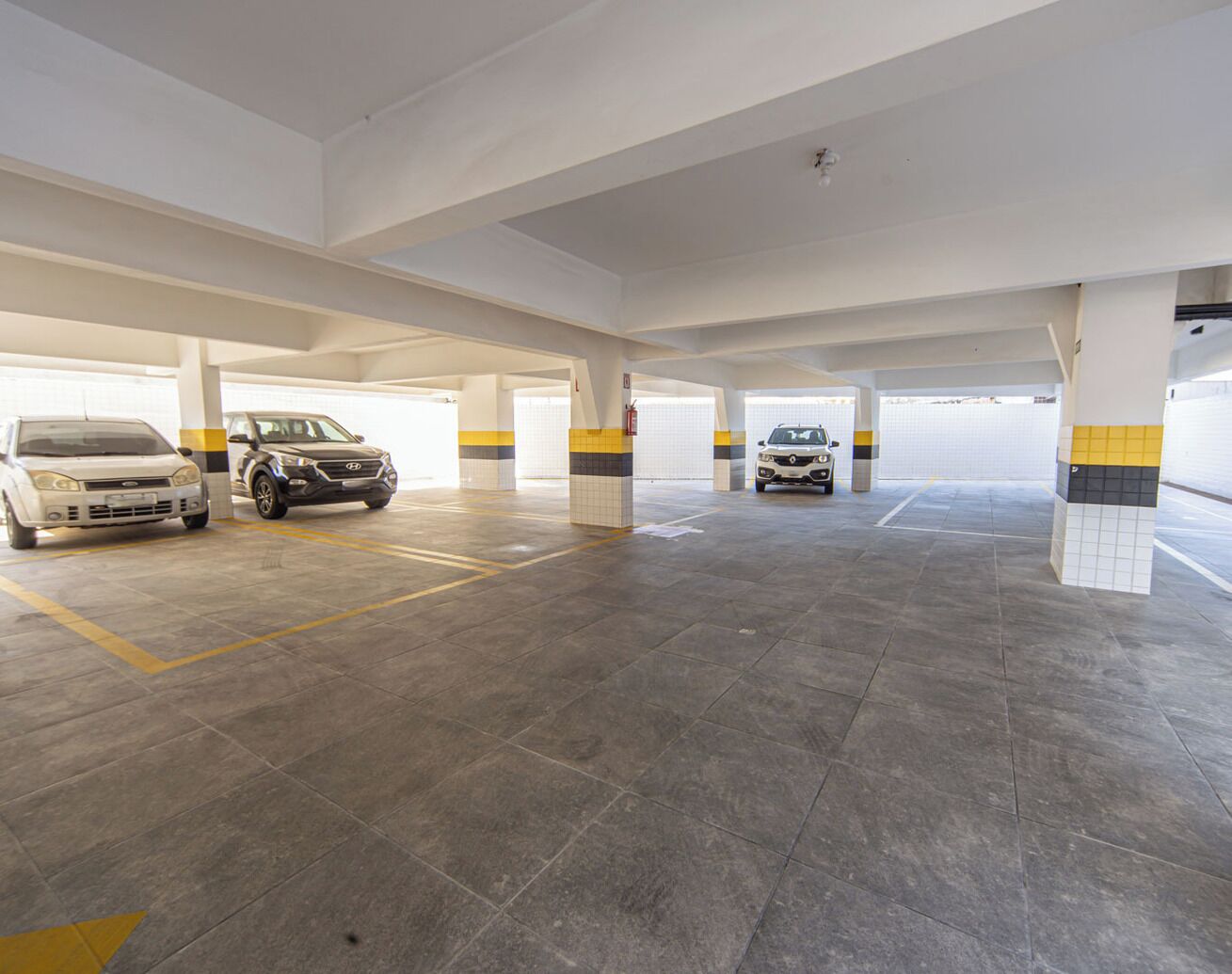 A multi-level parking garage with several cars parked.