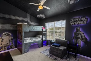 A Star Wars-themed bedroom with bunk beds, a ceiling fan, and a window with blinds. - 3BR Pool Villa w Resort Access, Disney Area (Kissimmee)