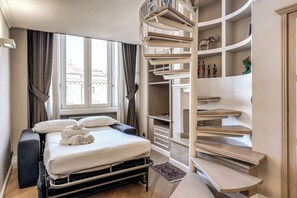 A hotel room with a bed, a wardrobe, and a spiral staircase. - Dolce Vita apartment in Central Roma with AC and kitchen (Roma)