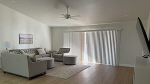 A modern living room with a sofa set, a round coffee table, and a ceiling fan. - Newly Remodeled Mesa Oasis with a Sparkling Pool—Move-In Ready & Stunning! (Mesa)