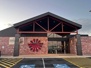 A brick building with a large sign reading 'Treendale Farm Hotel' and a parking lot with marked disabled parking spaces. - Hibiscus Haven in Eaton (Eaton)