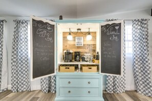 A kitchen with a chalkboard menu, a coffee machine, and a wooden counter. - Sleeps 20 | 3 Miles to Beach | Fire Pit & BBQ (Galveston)