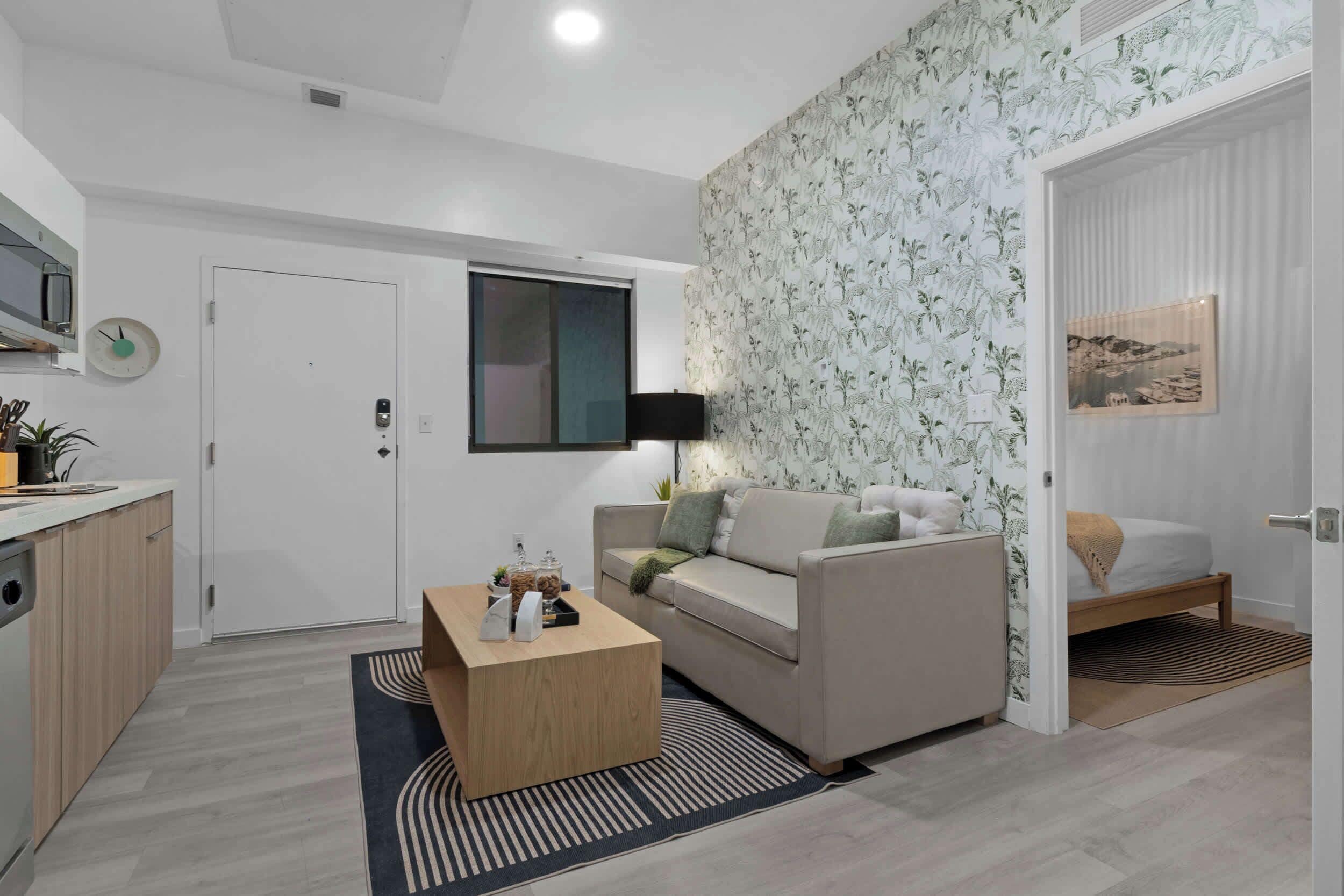 A modern living room with a sofa, coffee table, and a TV.