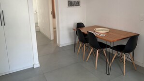 A dining area with a wooden table, black chairs, and a white pendant light. - Retreat with a view of Christ the Redeemer, South Zone of Rio de Janeiro (Rio de Janeiro)