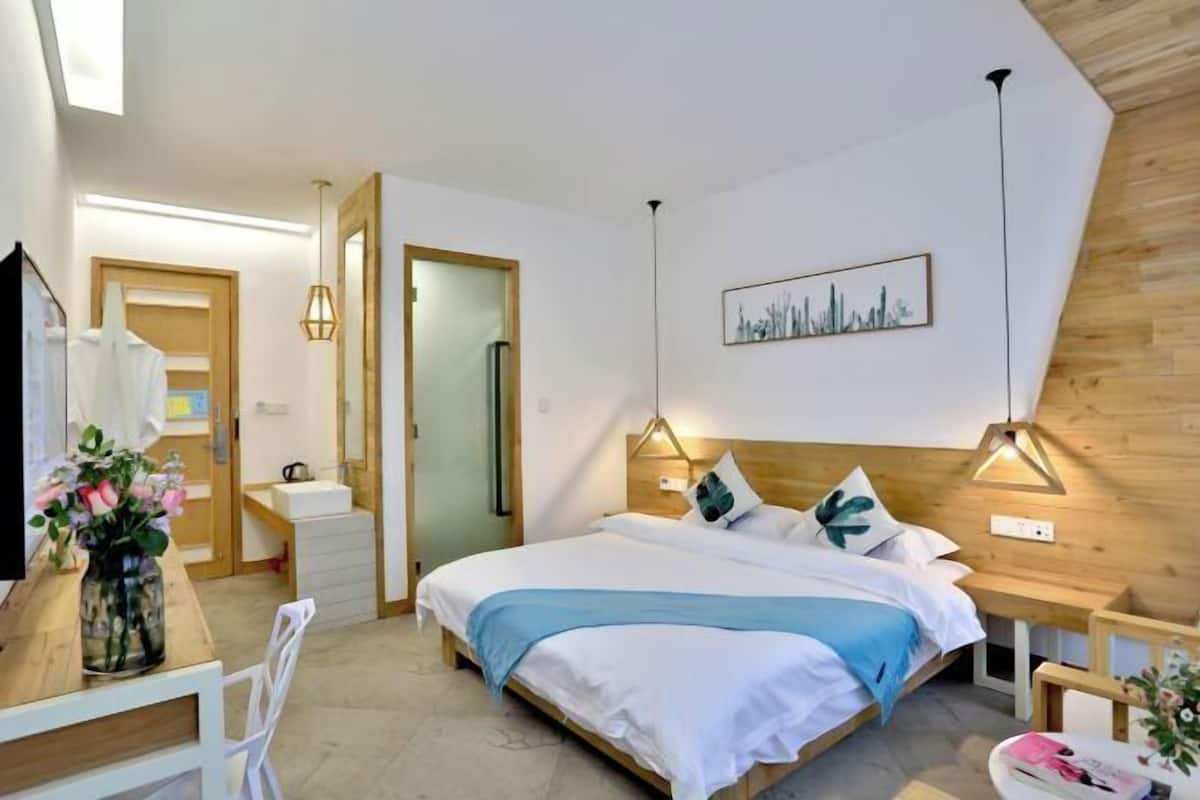 Ein modernes Schlafzimmer mit Bett, Nachttischen, Schreibtisch und Stuhl.