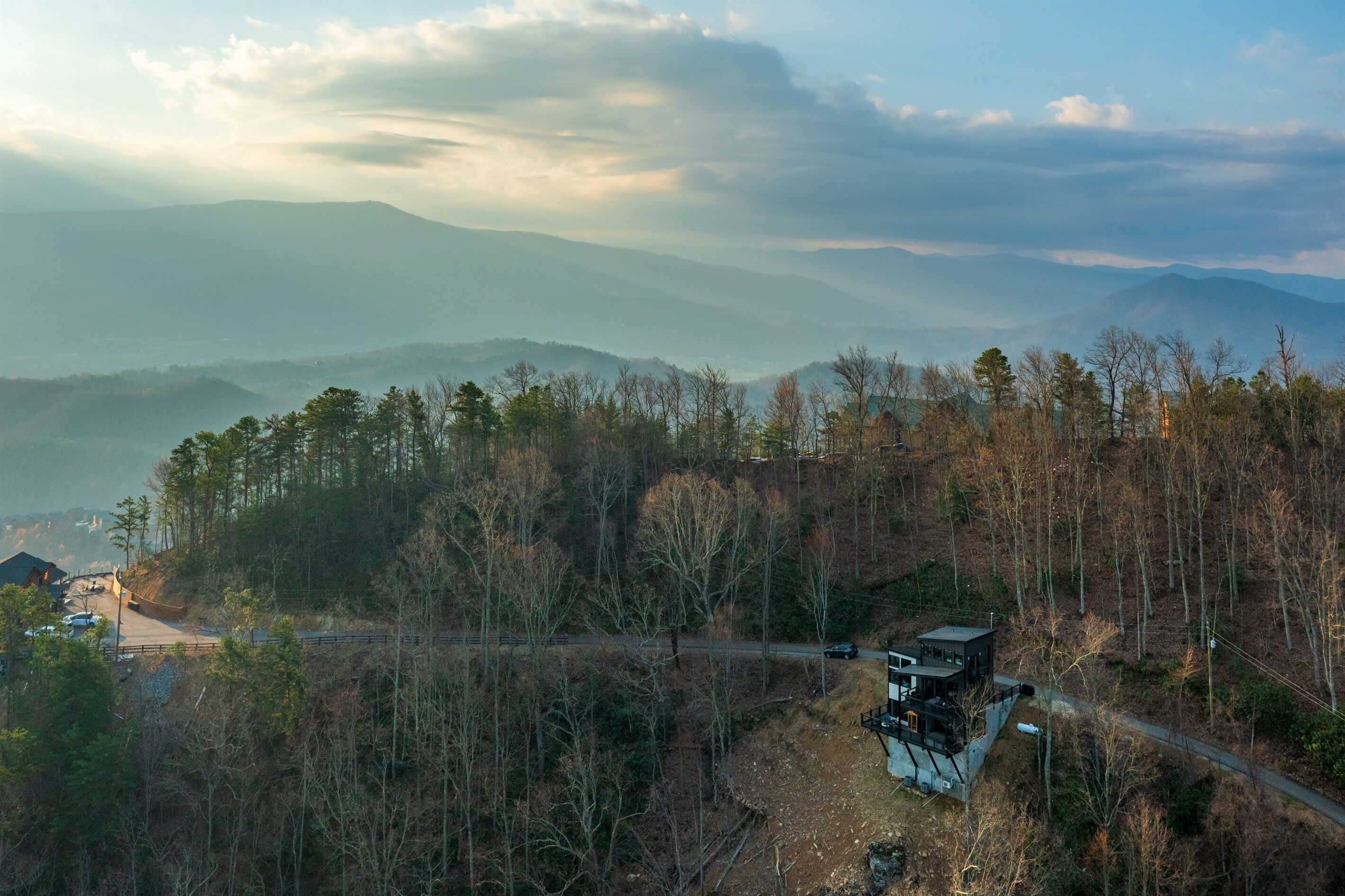 A remote cabin with a scenic mountain view, surrounded by dense forest.