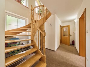 A wooden staircase leading to a landing with a view of a hallway and a door. - Penzion Natty by Interhome (Cerny Dul/Cista)