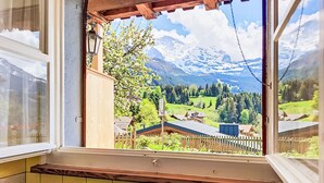 A kitchen with a window view of a mountainous landscape. - Chalet Graf Apt 1 by Interhome (Wengen)
