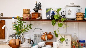 A kitchen with a coffee machine, tea kettle, and various kitchen utensils. - Hilltop Retreat Matale (Walewela)