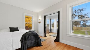 A bedroom with a bed, a window, and a view of the outdoors. - Newly renovated 2-bedroom apartment in quiet Historic Detroit neighborhood (Detroit)