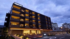 A modern hotel with multiple floors and balconies, featuring a prominent entrance and well-lit windows. - Rakuten STAY Awara Onsen (Awara)