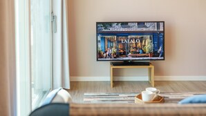 A television displaying a store named 'TALALO' with a modern interior and people walking outside. - Gangneung Dawon-hill Pension (Gangneung)