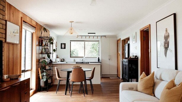 A modern kitchen with a dining area, wooden walls, and a large window. - StudioNESS Scamander (Break O'Day)