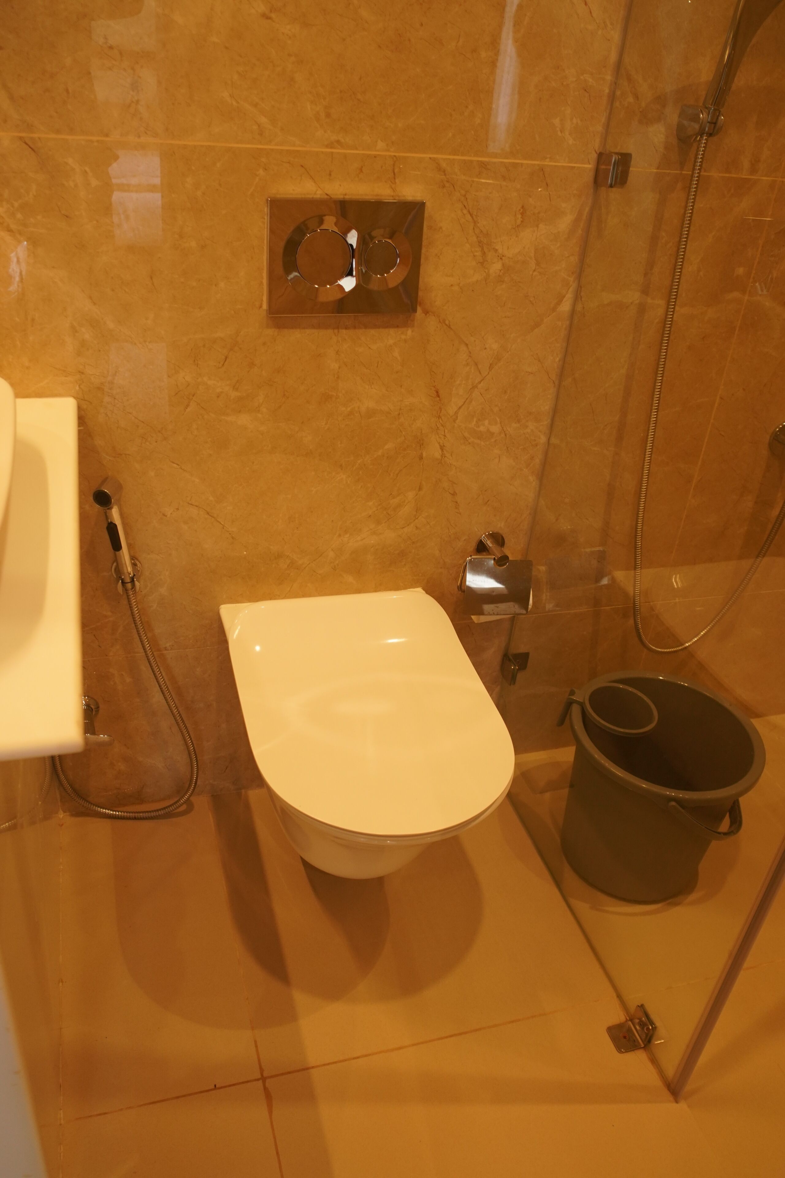 A bathroom with a toilet, a bidet, and a shower.